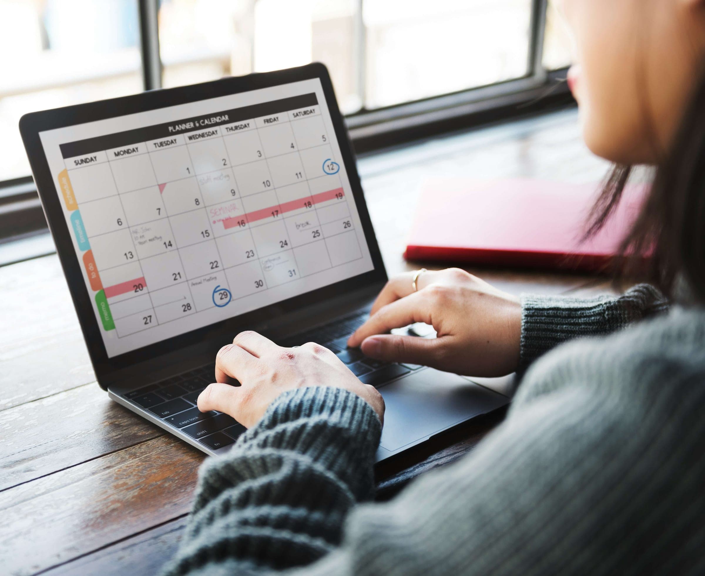 Someone booking an appointment on a calendar laid out on a laptop.